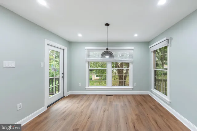 a kitchen with granite countertop a sink cabinets and wooden floor