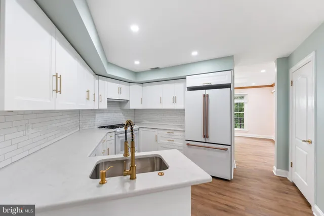 a view of a kitchen with a sink and a refrigerator