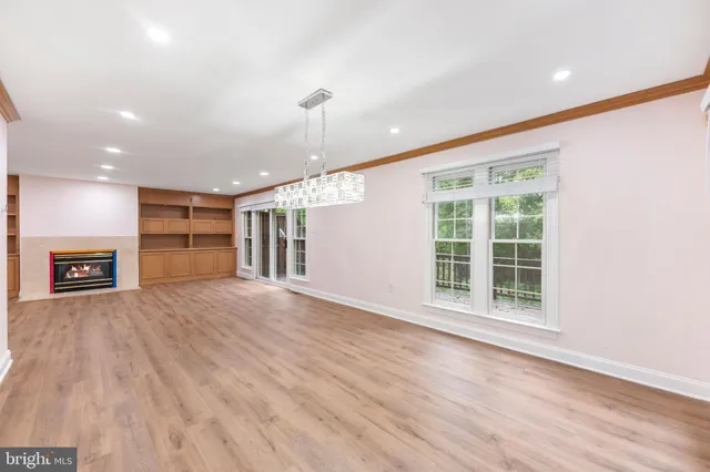a view of room with window and wooden floor