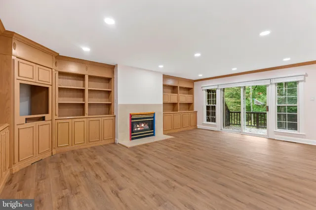 a view of a room with wooden floor and staircase
