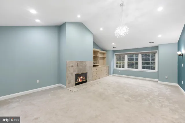 a view of an empty room with a fireplace