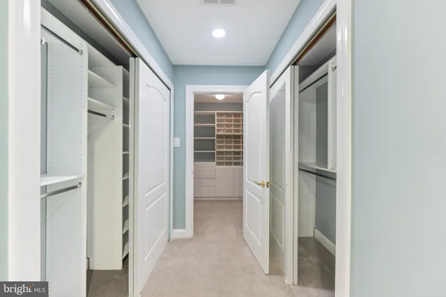 a spacious bathroom with a double vanity sink mirror and bathtub