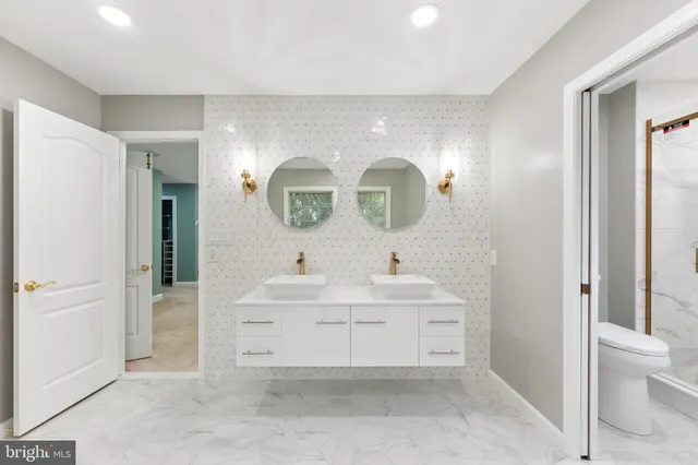 a bathroom with a tub double vanity sink and a mirror