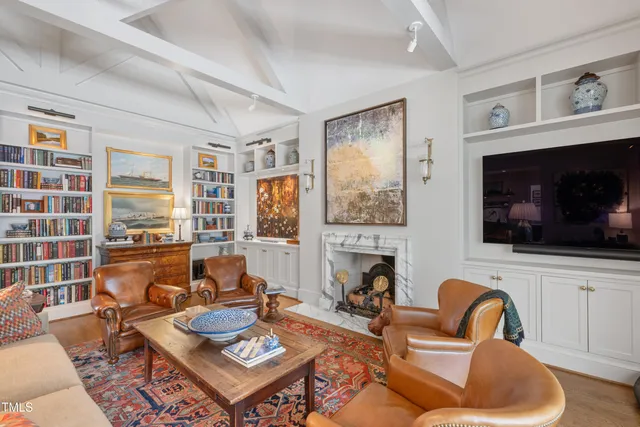 a living room with furniture fireplace and flat screen tv