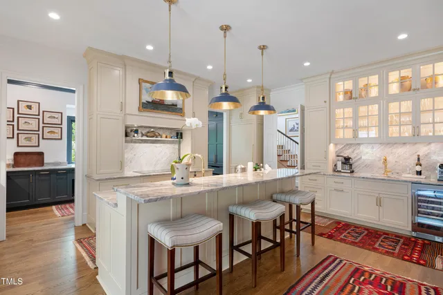 a kitchen with stainless steel appliances granite countertop a kitchen island a stove and a refrigerator