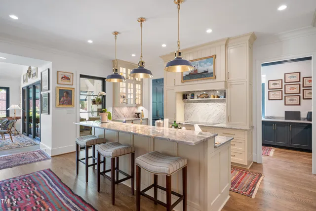 a large kitchen with a table and chairs