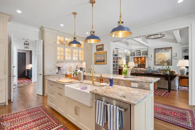 a kitchen with granite countertop a sink and a stove top oven