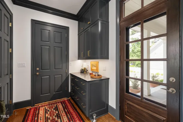 a living room with furniture and floor to ceiling windows