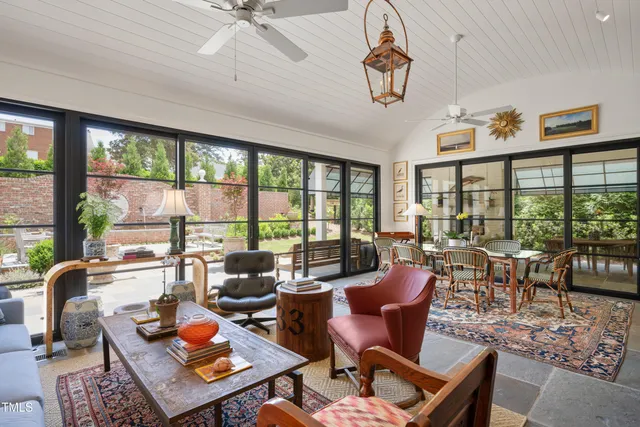 a living room with furniture fireplace and a large window
