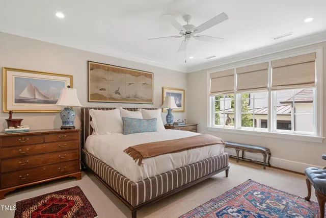 a bedroom with a bed couch and large window