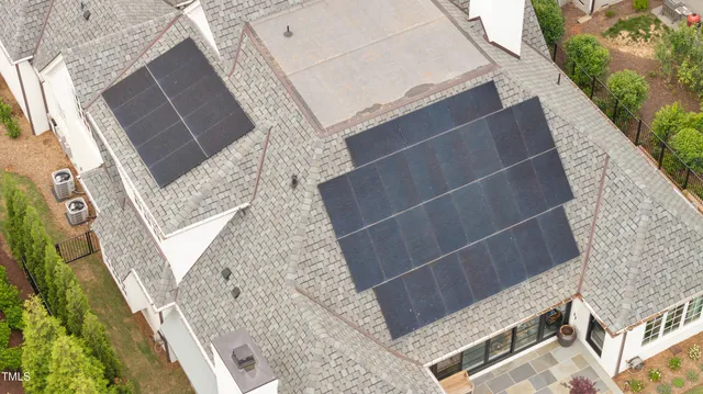 front view of a brick house with a yard