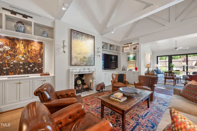 a living room with furniture a fireplace and a flat screen tv