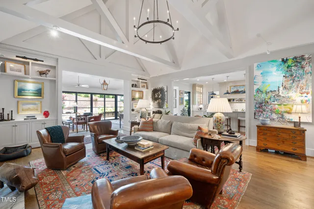 a living room with furniture a dining table and wooden floor