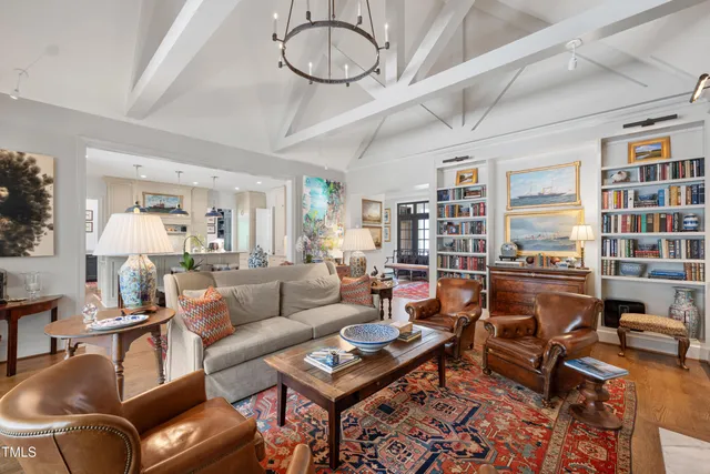 a living room with furniture a rug and a chandelier