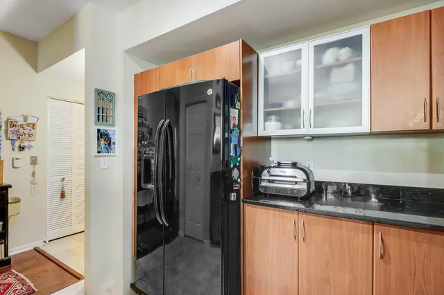 a kitchen with stainless steel appliances granite countertop a refrigerator and a sink