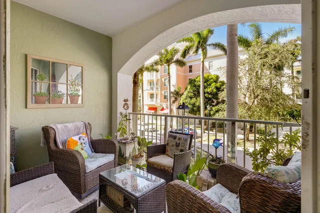 a balcony with furniture and a potted plant