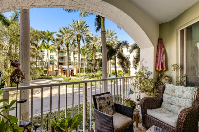 a view of a chairs and table in the balcony