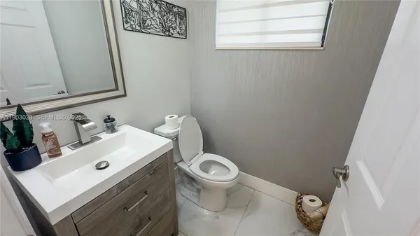 a white toilet sitting next to a white sink