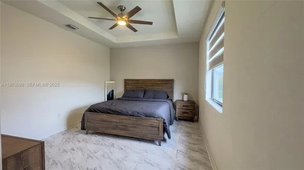 a bedroom with a bed and a window