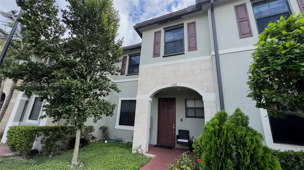 a view of front door and small plants
