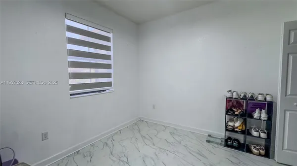 a view of a room with racks on the wall and a window