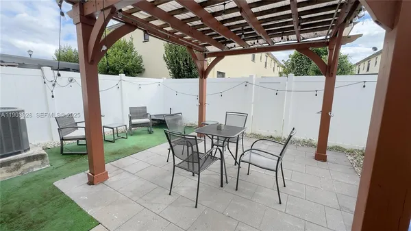 a view of a backyard with a patio and a garden