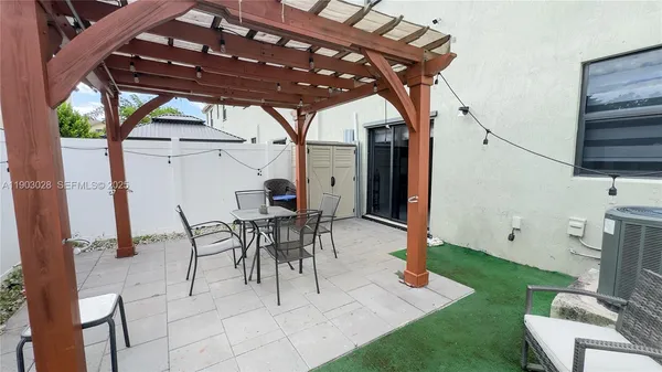 a patio with a table and chairs