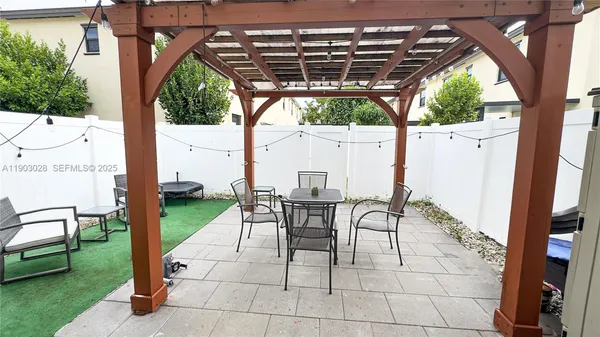 a patio with a patio table and chairs
