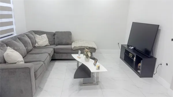 a living room with furniture and a flat screen tv