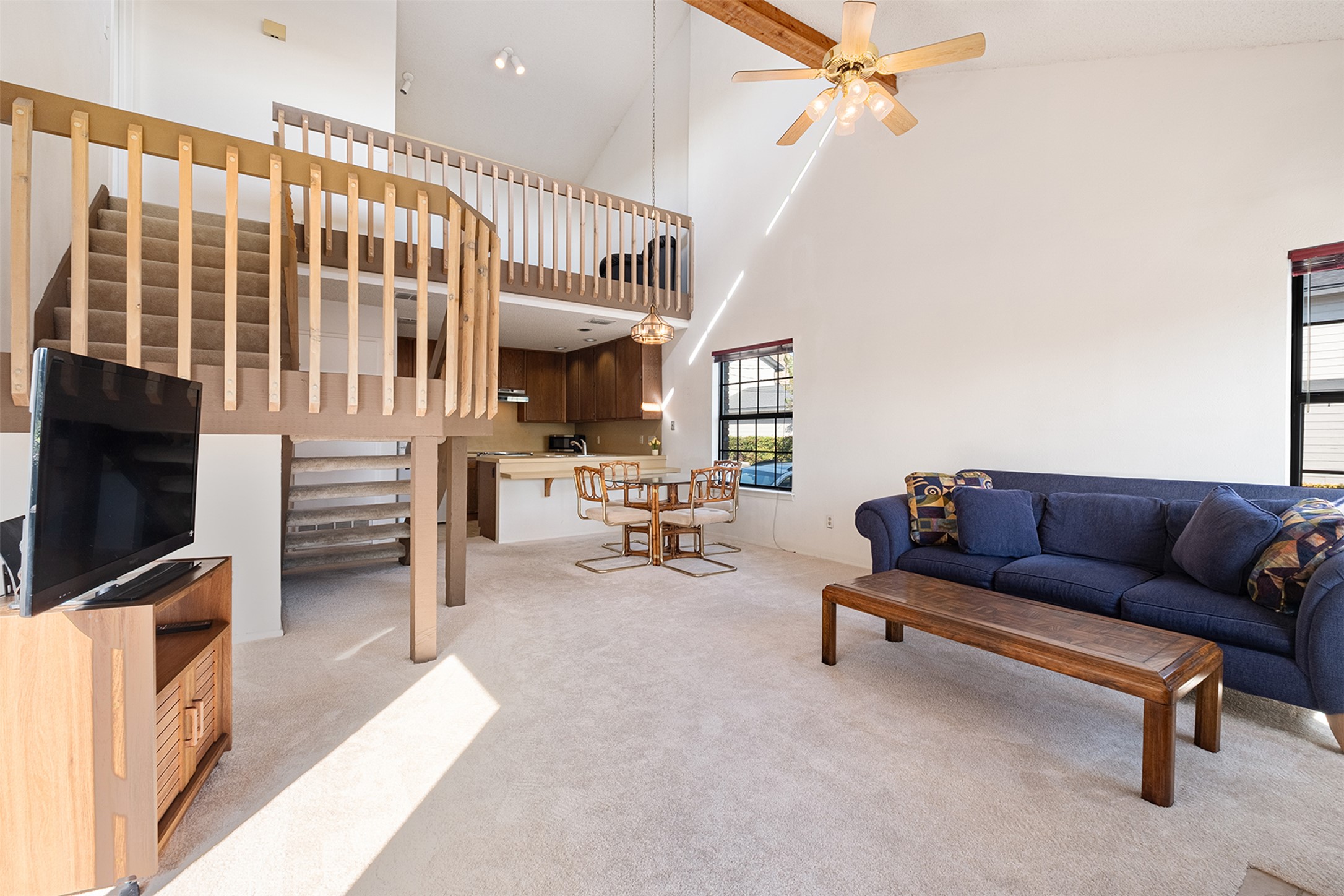 1748 Ohlen Road, Unit 16 Austin, TX 78757 - Photo 5 of 38 Living room featuring light colored carpet, a ceiling fan, and lofted ceiling