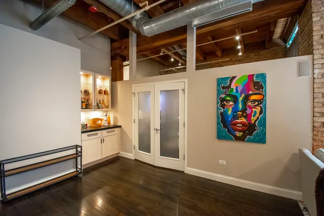 a view of a livingroom with wooden floor and furniture