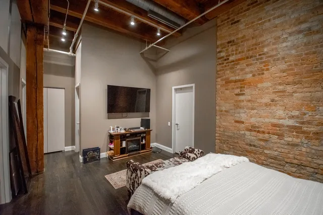 a bedroom with a bed and a flat screen tv