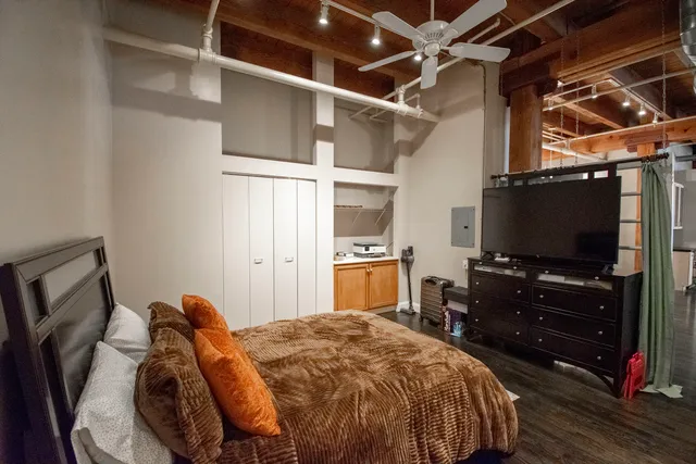 a bedroom with a bed and flat screen tv
