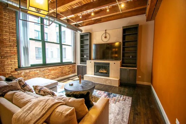 a living room with furniture a fireplace and a table