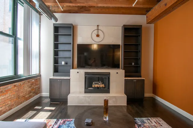 a living room with furniture and a fireplace