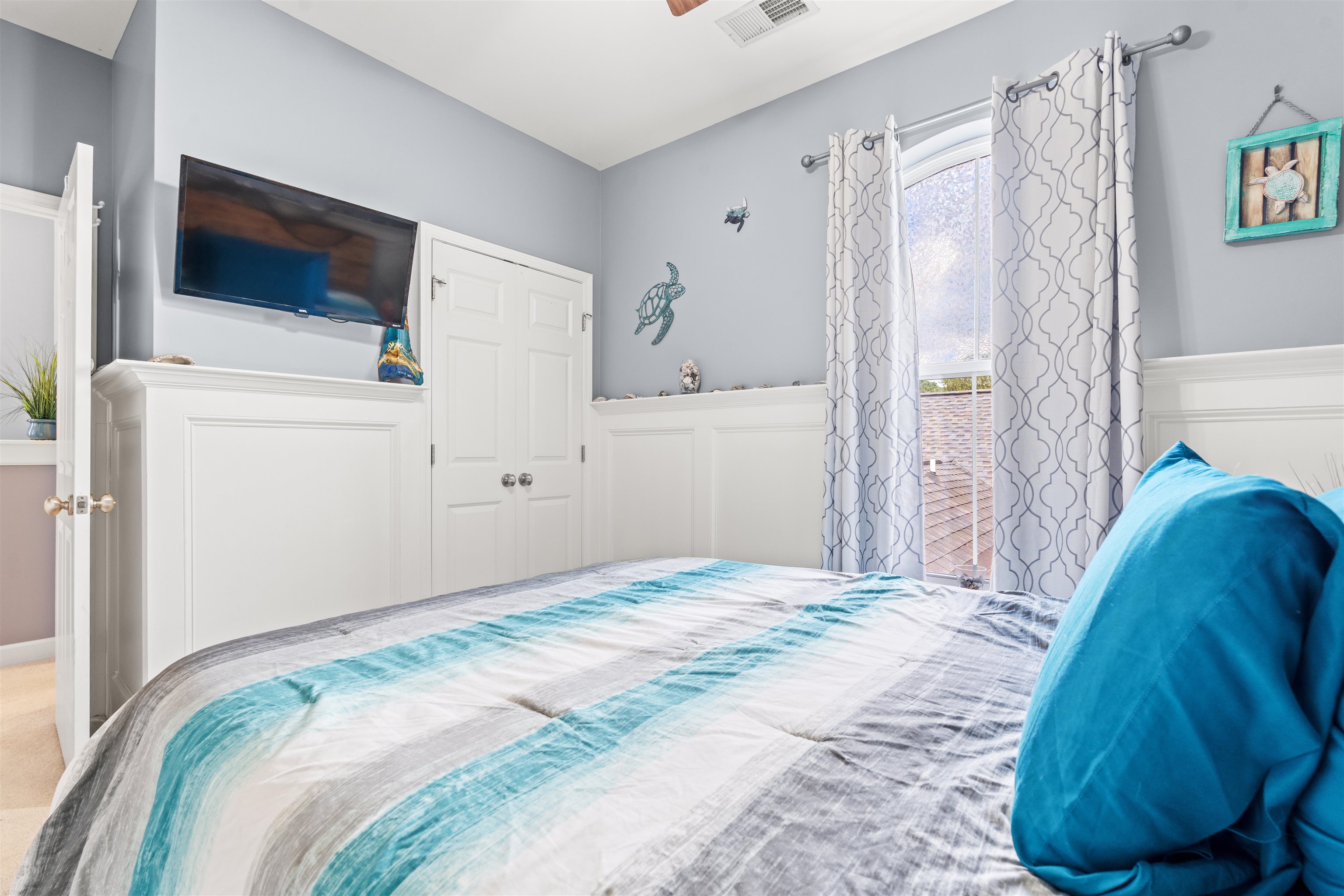 3512 Alexandria Avenue, Unit 18 Myrtle Beach, SC 29577 - Photo 22 of 31 Bedroom with wainscoting, a decorative wall, and a ceiling fan