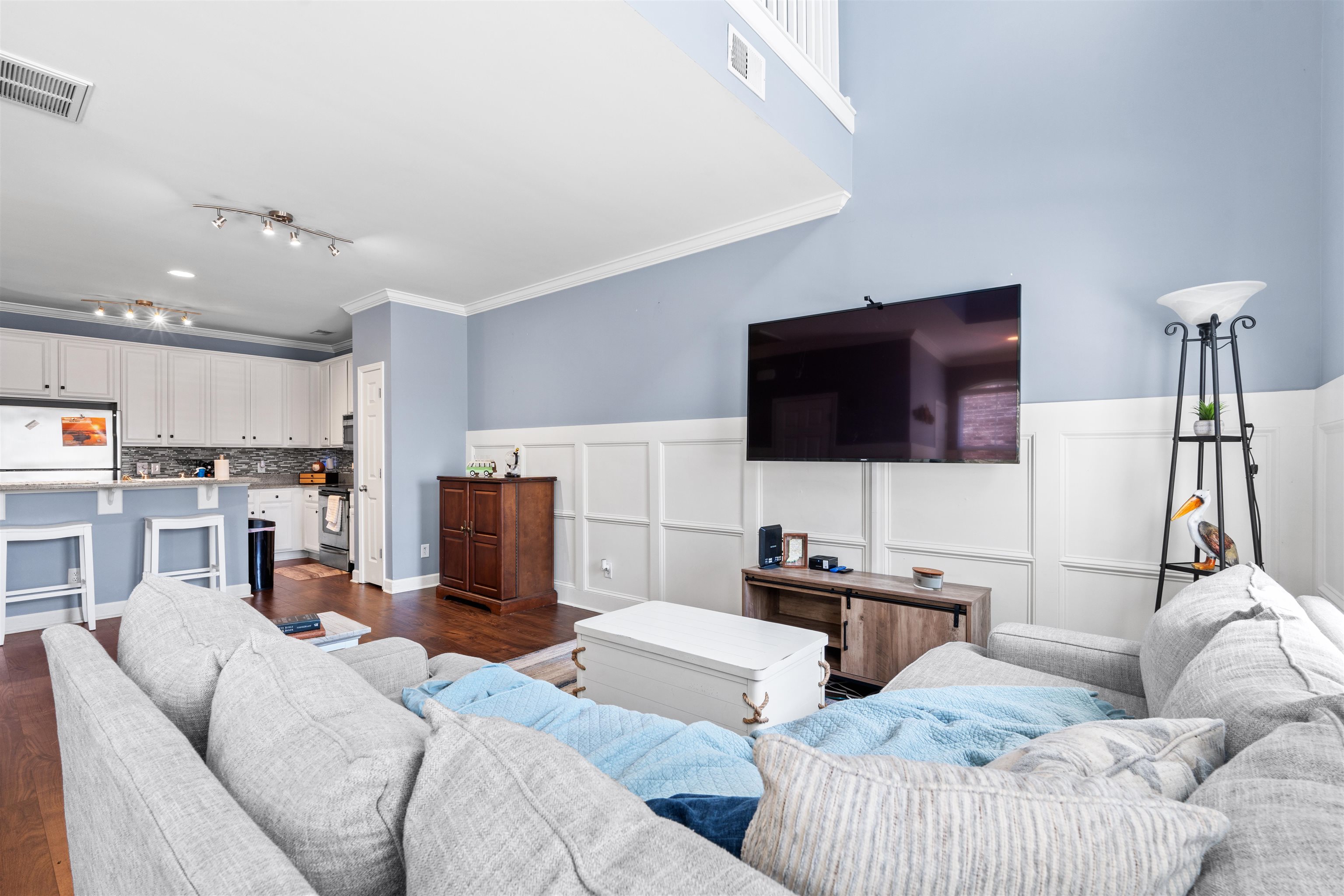 3512 Alexandria Avenue, Unit 18 Myrtle Beach, SC 29577 - Photo 4 of 31 Living room with wainscoting, ornamental molding, a decorative wall, and dark wood-style floors