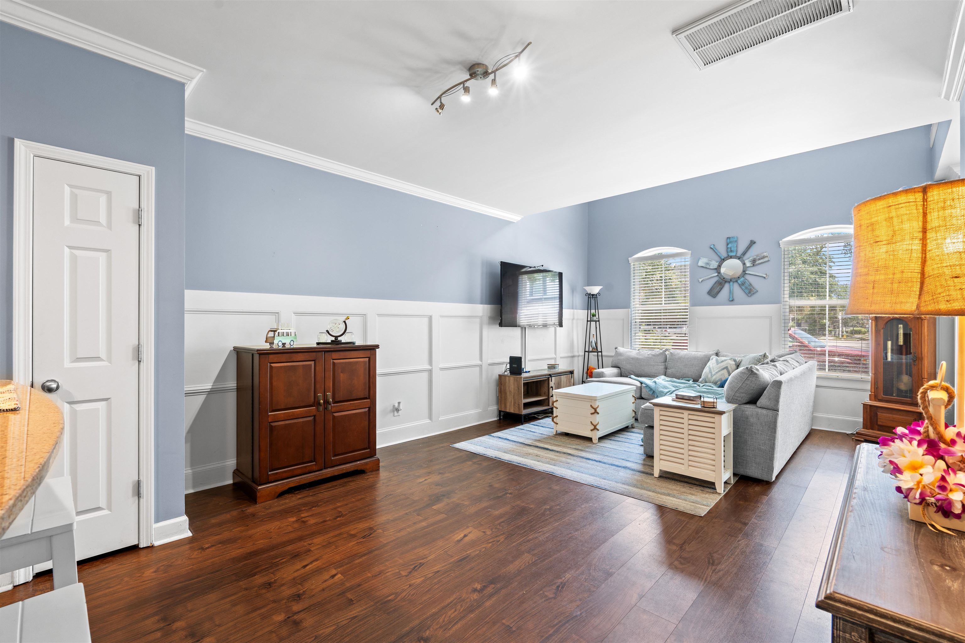 3512 Alexandria Avenue, Unit 18 Myrtle Beach, SC 29577 - Photo 5 of 31 Living room featuring dark wood-style flooring, crown molding, wainscoting, and a decorative wall