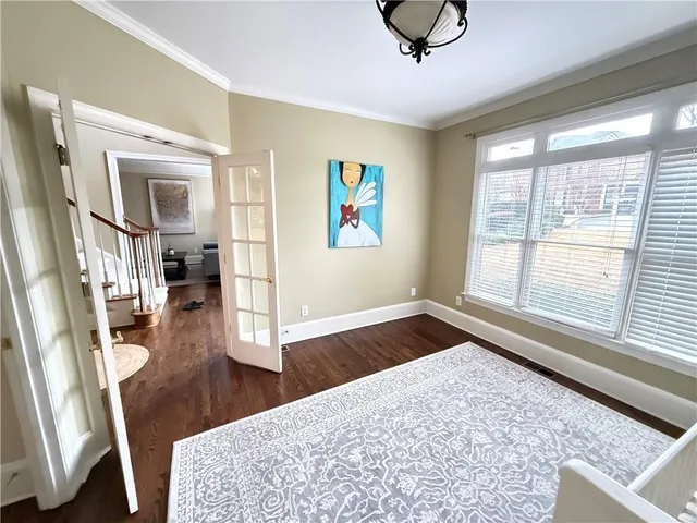 a living room with large window and wooden floor