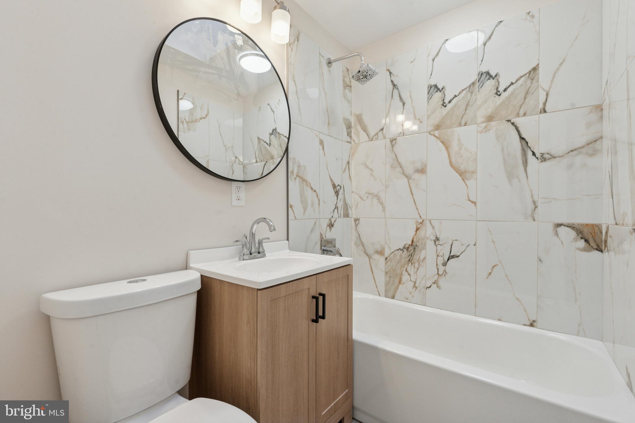 8327 Forrest Avenue Philadelphia, PA 19150 - Photo 12 of 14 a bathroom with a sink a toilet and a mirror