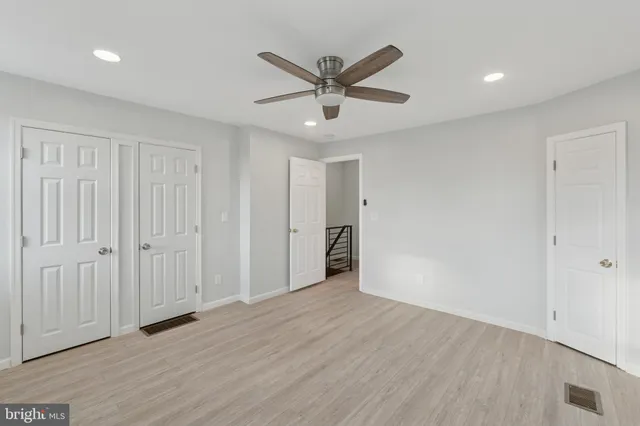 wooden floor in an empty room with a ceiling fan