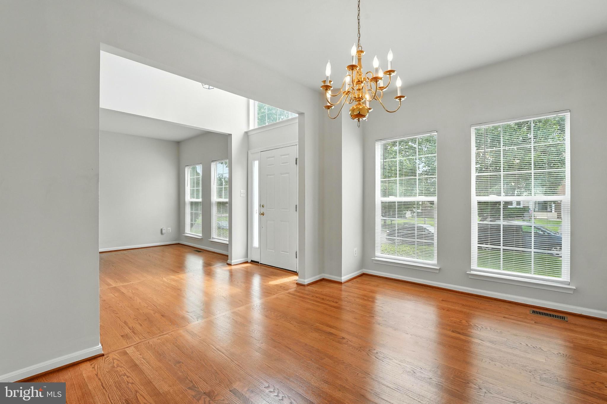705 Holly Leaf Road Culpeper, VA 22701 - Photo 13 of 62 a view of an empty room with wooden floor and a window