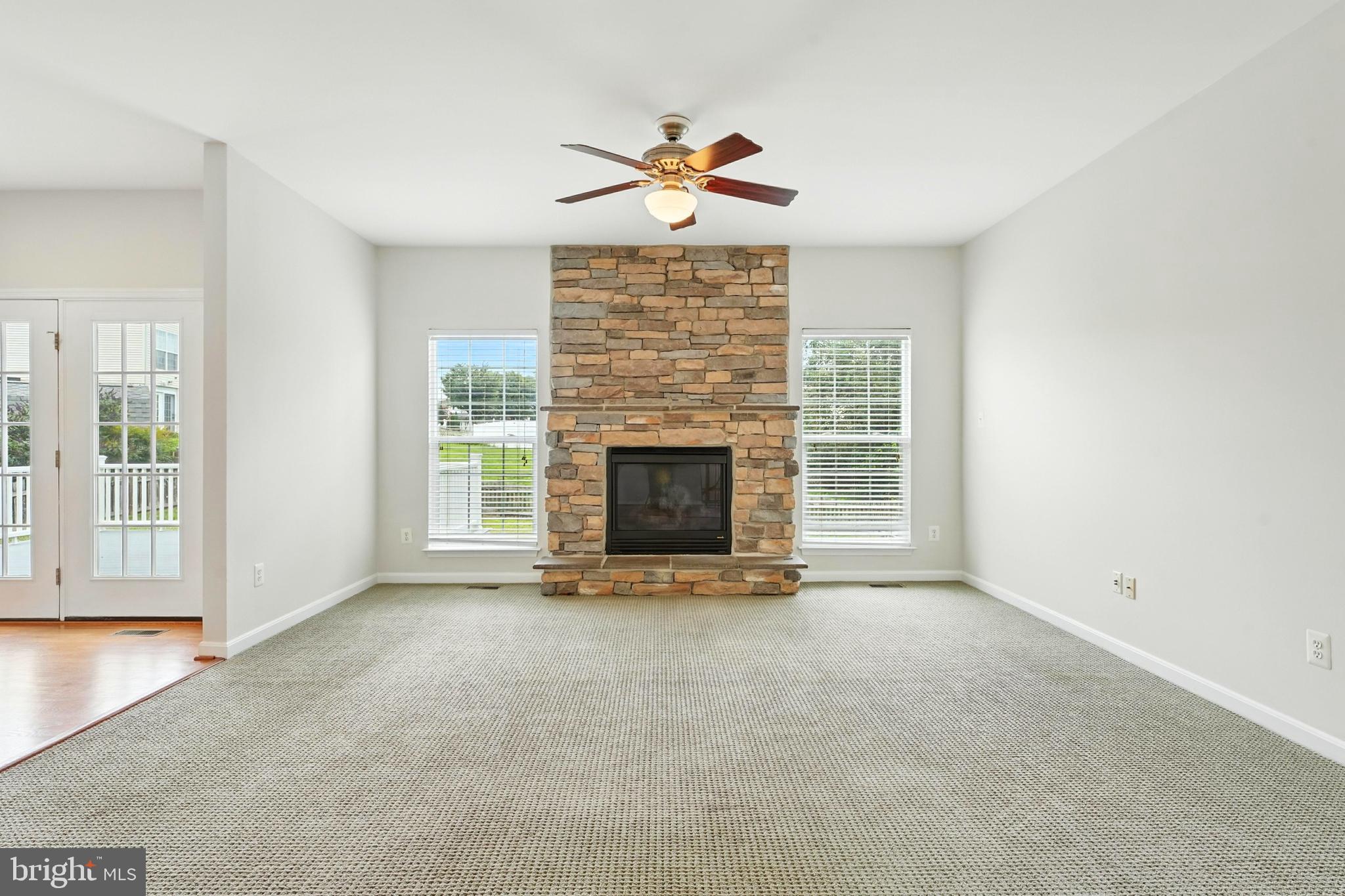 705 Holly Leaf Road Culpeper, VA 22701 - Photo 19 of 62 an empty room with windows and fireplace