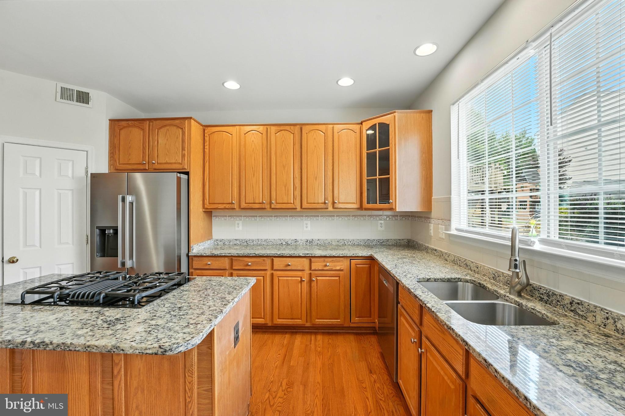 705 Holly Leaf Road Culpeper, VA 22701 - Photo 23 of 62 a kitchen with stainless steel appliances granite countertop a sink stove and refrigerator