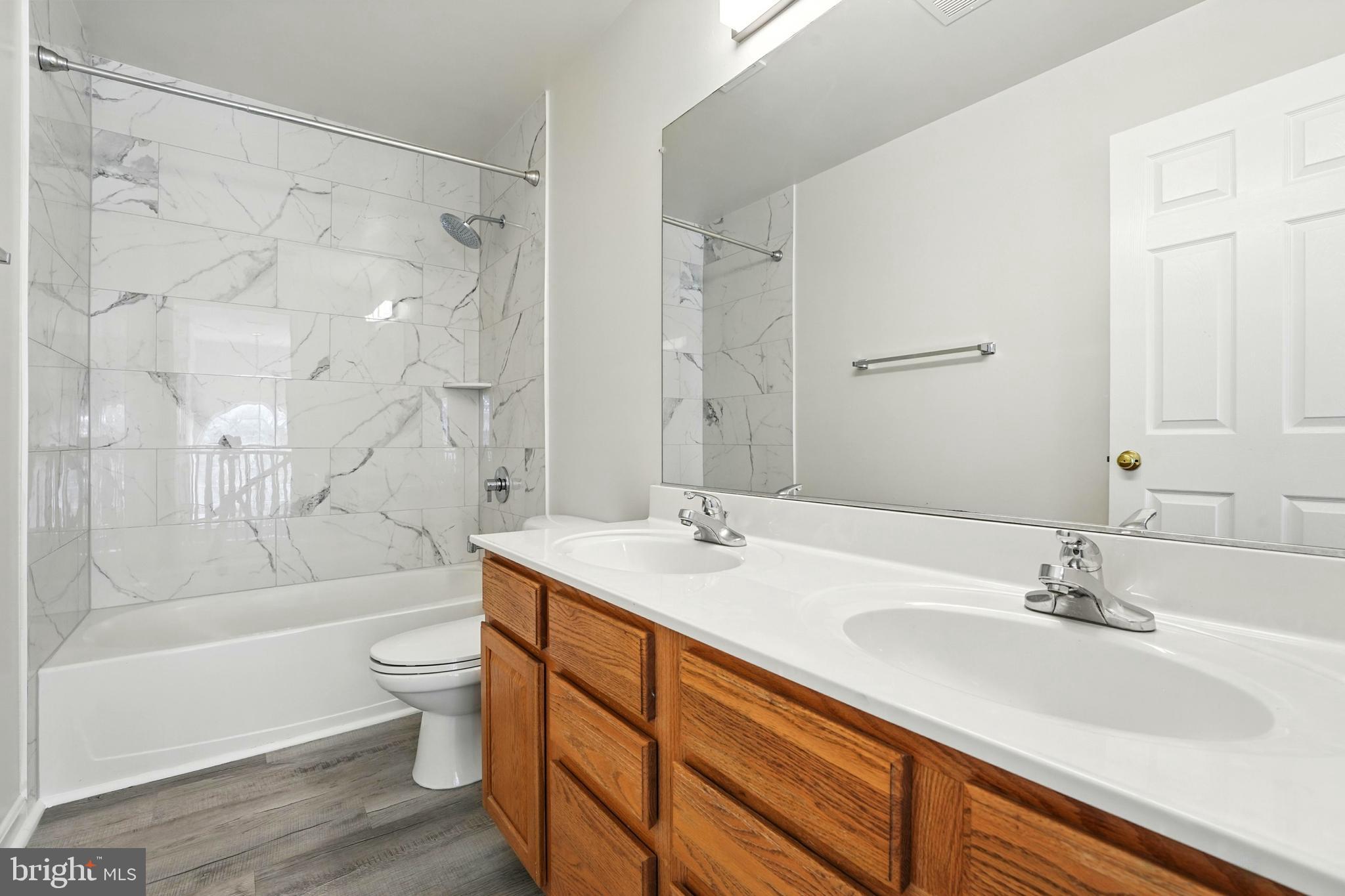 705 Holly Leaf Road Culpeper, VA 22701 - Photo 35 of 62 a bathroom with a bathtub shower sink mirror and toilet