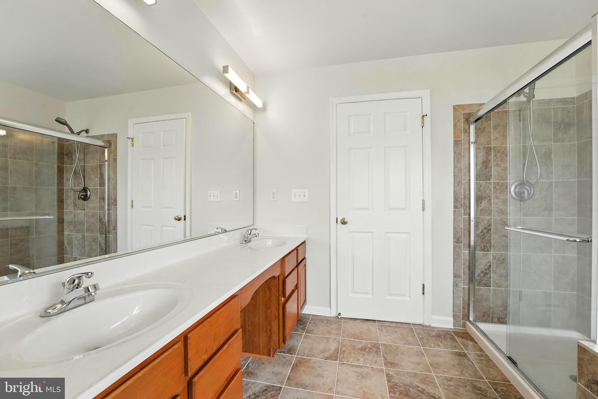 705 Holly Leaf Road Culpeper, VA 22701 - Photo 44 of 62 a bathroom with a tub sink shower and a mirror