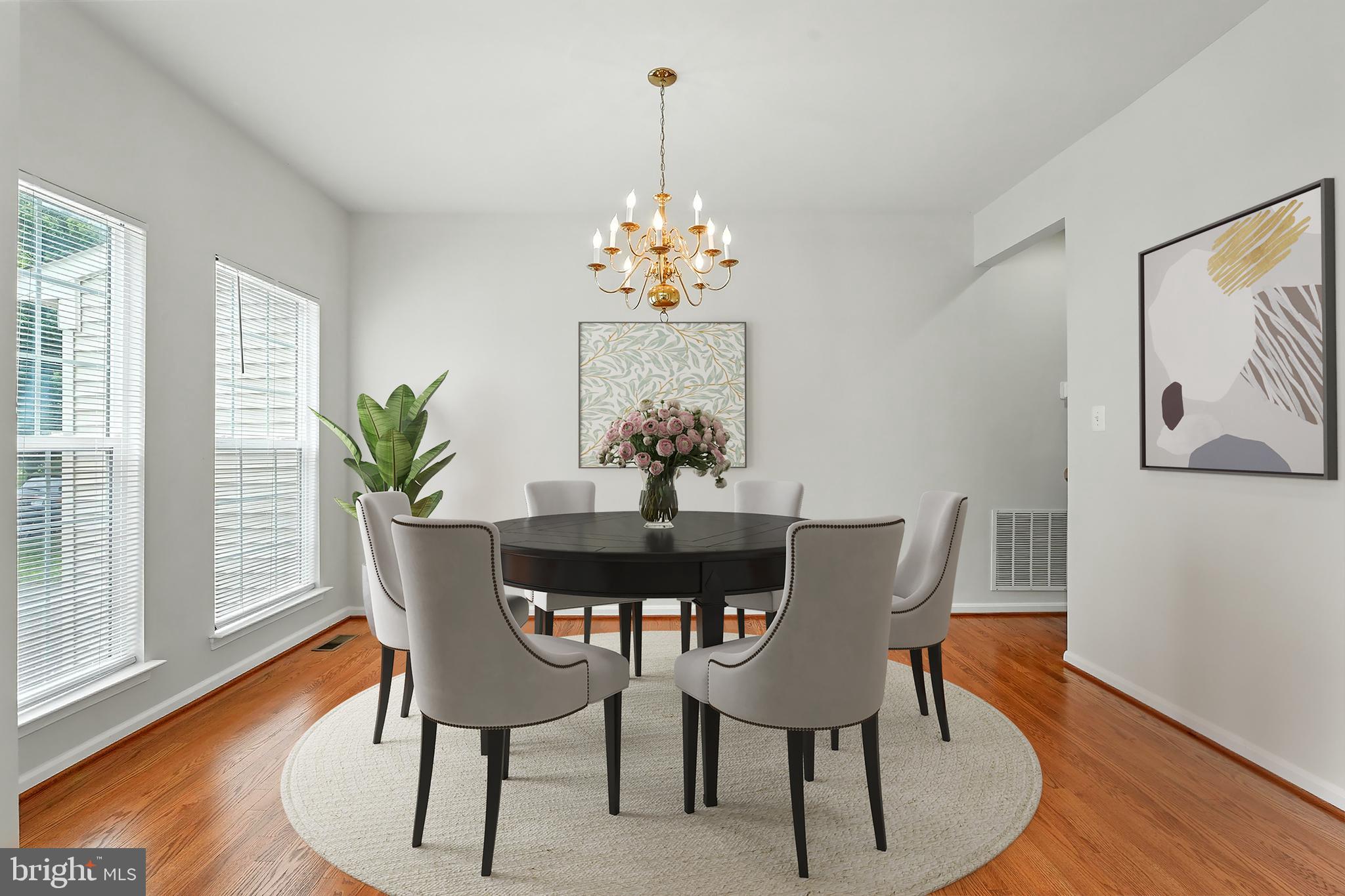 705 Holly Leaf Road Culpeper, VA 22701 - Photo 5 of 62 a dining room with furniture potted plants and wooden floor