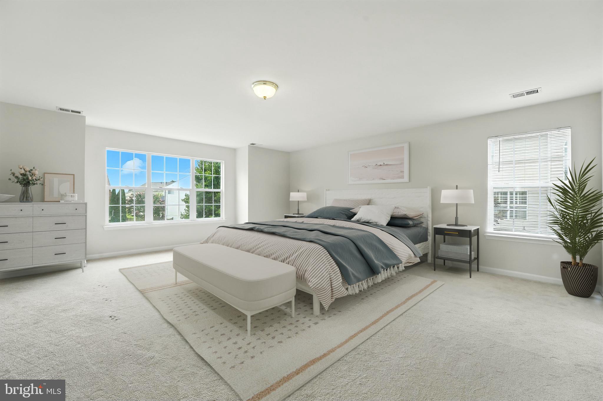 705 Holly Leaf Road Culpeper, VA 22701 - Photo 6 of 62 a bedroom with a large bed and a potted plant