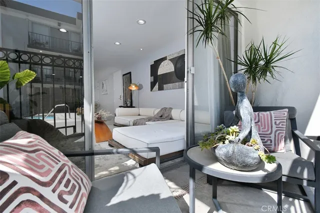 a living room with furniture and a potted plant