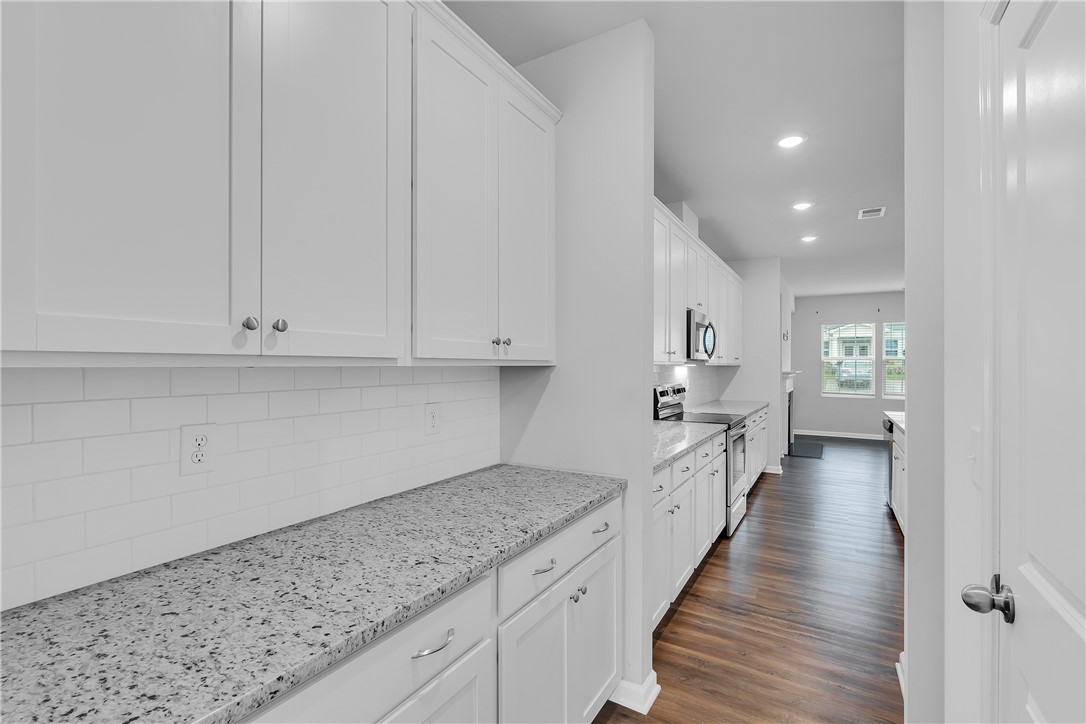 8 Leander Drive Greer, SC 29651 - Photo 16 of 31 Clean lines define this bright kitchen featuring generous counter space and classic white cabinetry.